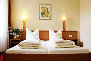 a hotel room with a bed with white sheets and pillows at Air in Berlin in Berlin