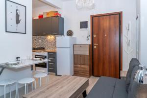 a small kitchen with a table and a refrigerator at Kosmos Service Apartment Near Saint Dimitrious Church in Thessaloniki