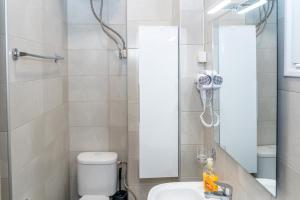 a bathroom with a shower with a toilet and a sink at Kosmos Service Apartment Near Saint Dimitrious Church in Thessaloniki +70 photos
