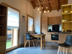 a kitchen with a wooden table and chairs in it at Appartement Rêve de Montagne in Samoëns