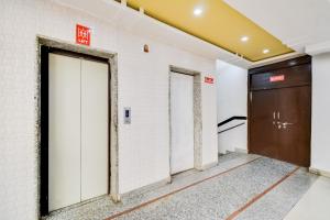 a row of elevators in a building with a door at OYO Hotel Amber Palace in Bārmer