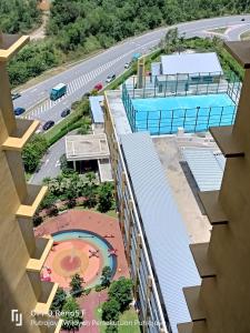 an aerial view of a building with a swimming pool at KASTURI GUEST HOUSE PUTRAJAYA in Putrajaya