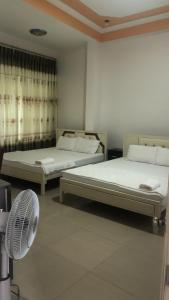 藩郎的住宿－Nam Dương 3 Hotel，带风扇的客房内的两张床
