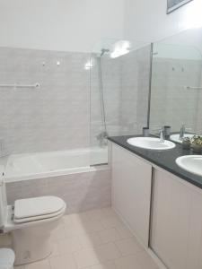 a bathroom with a toilet and a sink and a shower at Great View City Appartment in Agios Rokkos +4 photos