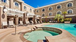 a swimming pool in front of a building at Best Western Plus Abbey Inn in St. George
