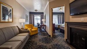 a living room with a couch and a fireplace at Best Western Plus Abbey Inn in St. George