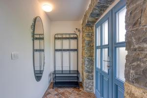 a hallway with a blue door and a window at Istrian Casa Pr Marici in Pobegi +42 photos