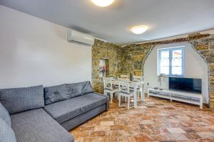 a living room with a couch and a table at Istrian Casa Pr Marici in Pobegi