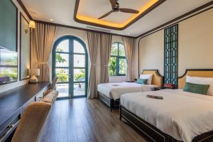 a hotel room with two beds and a window at Stella Marina Boutique Hotel in Phú Quốc