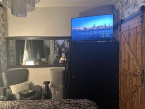 a bedroom with a flat screen tv on the wall at Luxury one bedroom condo in Kitchener