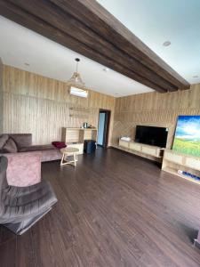 a living room with a couch and a tv at Sapa J&K Homestay and Swimming Pool in Sa Pa