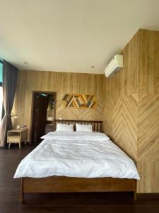 a bedroom with a large bed with wooden walls at Sapa J&K Homestay and Swimming Pool in Sa Pa