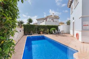 a swimming pool in the backyard of a house at Mar Menor Golf Resort - 117 in Las Casicas