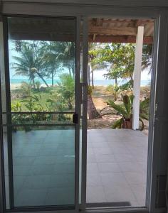 an open door with a view of the ocean at The Rock Coco Villa in Ban Laem Pom