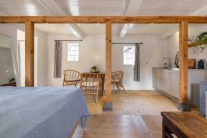 a room with a bed and a kitchen and a table at Solbjerggaard Studio Apartments in Faaborg