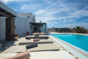 a villa with a swimming pool and a house at Villa Irilia, Private Pool with Unrestricted Sea View in Fanari