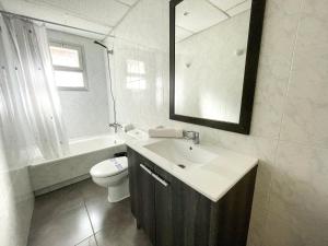 a bathroom with a sink and a toilet and a mirror at Bungalows Pescador in Segur de Calafell