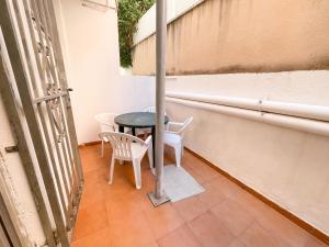 a small table and chairs on a balcony at Bungalows Pescador in Segur de Calafell