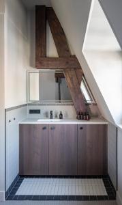 an attic kitchen with wooden cabinets and a sink at New Park Edition in Venlo