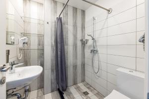 a bathroom with a sink and a shower at Amber Drop apartments in Palanga +50 photos