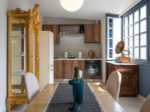 a kitchen with a table and chairs and a refrigerator at Loft 038 City Center in Heraklio