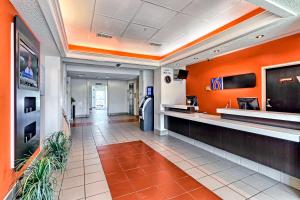 a lobby of a fast food restaurant with orange walls at Motel 6-Killeen, TX in Killeen