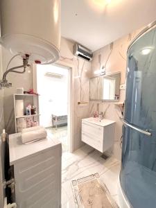 a bathroom with a shower and a sink at Apartment M&M Izola in Izola