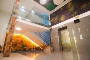 a lobby of a building with a mural of plants at Go Hotels Iloilo in Iloilo City