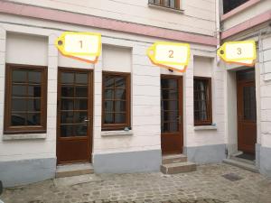 a facade of a building with doors with numbers on them at studi'home in Rouen