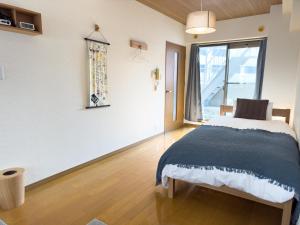 Postel nebo postele na pokoji v ubytování AMP FLAT Nishijin 4