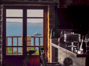a view of the ocean from a room with a window at Ethaleia Hotel in Moúdhros