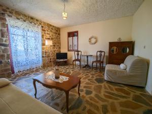 a living room with a couch and a table at Ethaleia Hotel in Moúdhros +22 photos