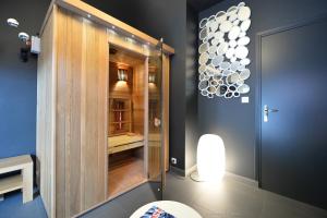 a bathroom with a toilet and a glass shower at Best Western Auray le Loch in Auray