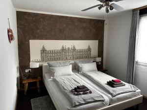 a bedroom with a large bed with two towels on it at City B&B Cochem in Cochem