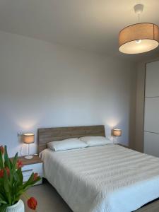 ローマにあるLa Terrazzaのベッドルーム1室(大型ベッド1台、ランプ2つ付)