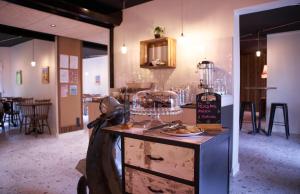 a room with a counter with a plate of food on it at The Originals Access, Hôtel Limoges Nord in Limoges