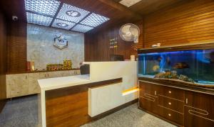 a large aquarium in a room with a fish tank at Itsy By Treebo - Yogeshwara Grand in Shamshabad