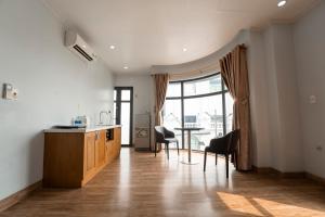 Riverside Row Apartment في دونغ هوي: مطبخ وغرفة طعام مع طاولة وكراسي