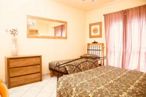 a bedroom with two beds and a dresser and a mirror at Relax Home,nel cuore della Valle D’Aosta in Montjovet