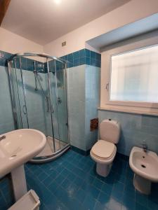 a bathroom with a shower and a toilet and a sink at Apartment Da Pupetta in Sori