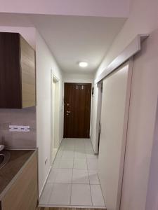 a hallway leading to a kitchen with a door at Forest View Apartment in Mavrovo