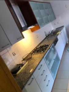 a kitchen with a stove and a counter top at Apartamento Lisboa Parque das Nações in Lisbon