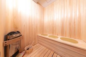 a sauna with a bench in a wooden room at 瀬戸内 TABITO in Yoshimi