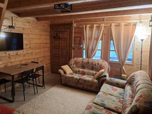 a living room with a couch and a table at brvnara Morava in Ovčar Banja
