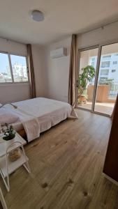 a bedroom with a large bed and a large window at City Center Apartment 2 in Strovolos