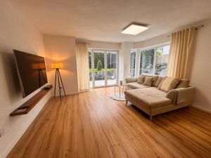 a living room with a couch and a flat screen tv at FeWo Haus am Bodensee in Friedrichshafen