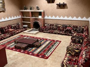 a living room filled with furniture and a fireplace at شاليهات حائط طيني in Riyadh