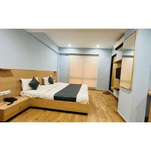 a bedroom with a large bed in a room at The Berlin in Gandhinagar