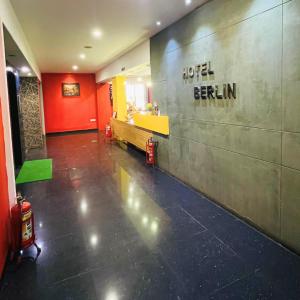a restaurant with the words hotel berlin on the wall at The Berlin in Gandhinagar