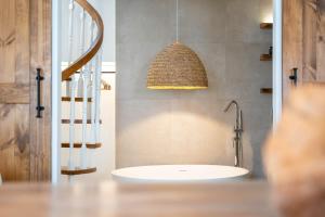 ein Badezimmer mit einem Waschbecken und einer Hängeleuchte in der Unterkunft 57 Bee OLD TOWN Lagos - house near beach & Marina in Lagos